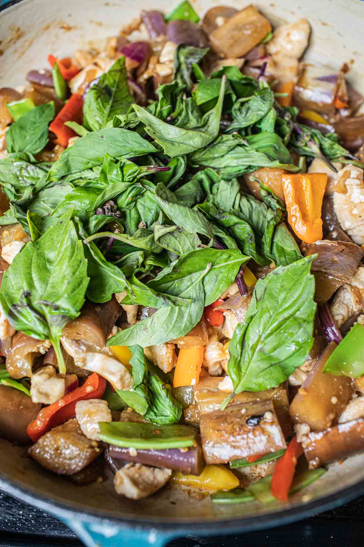 basil in a stir frying pan with eggplant and chicken