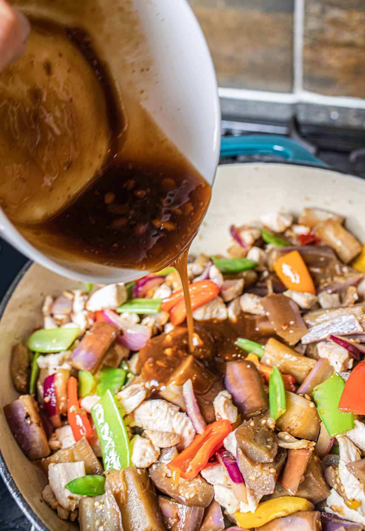 Sauce pouring into eggplant stir fry