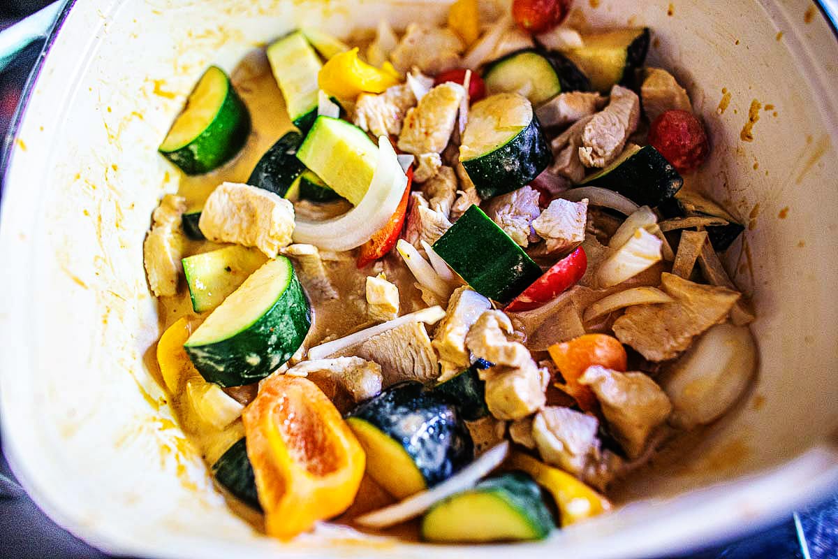 vegetables and chicken in a curry sauce in a pot