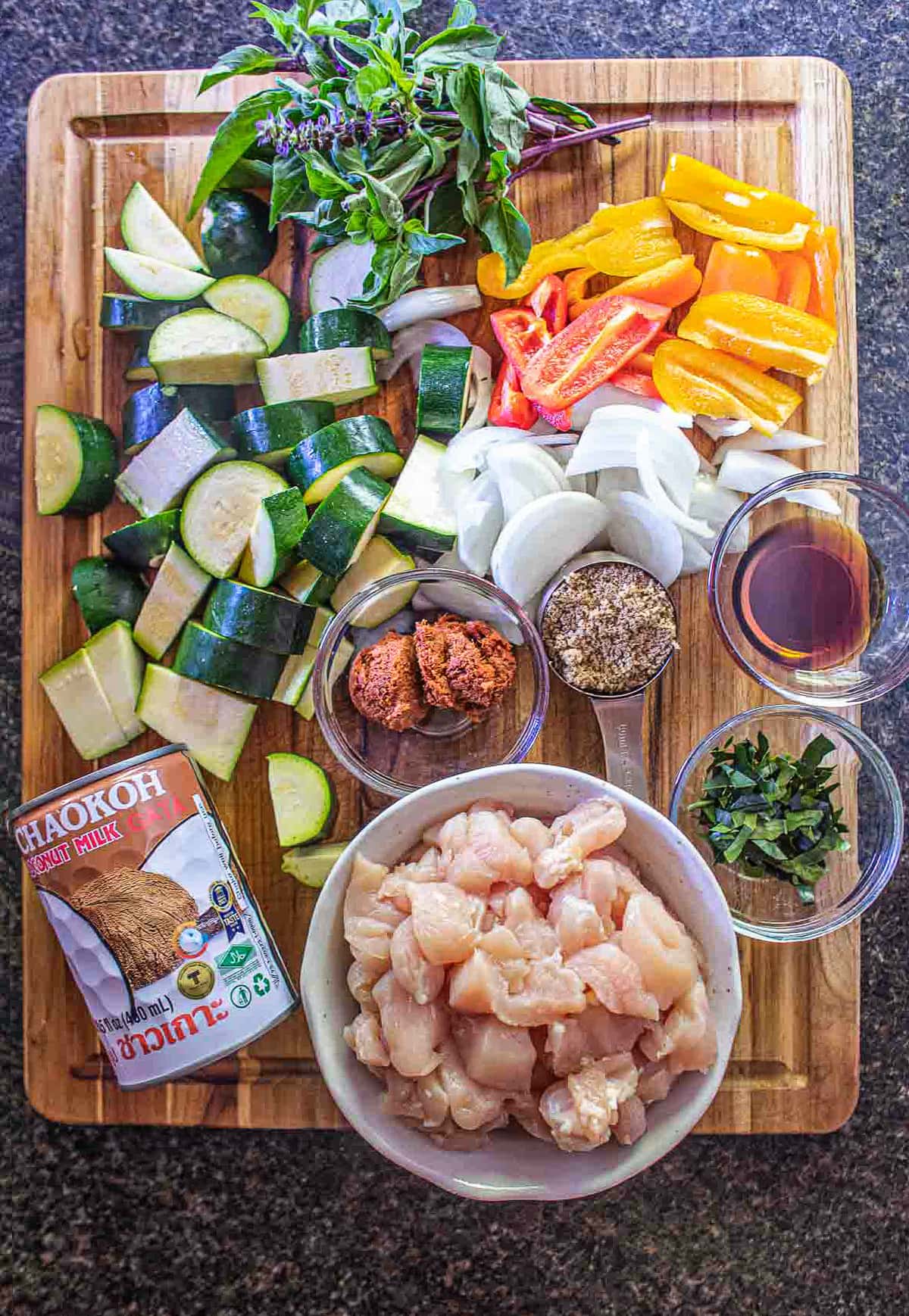 ingredients in zucchini curry on a big cutting board.