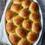 Golden Butternut Squash Dinner Rolls are flecked with rosemary and completely irresistible. Roasted squash cooked into the roll ensures that they are soft and full of flavor with just a hint of sweetness.