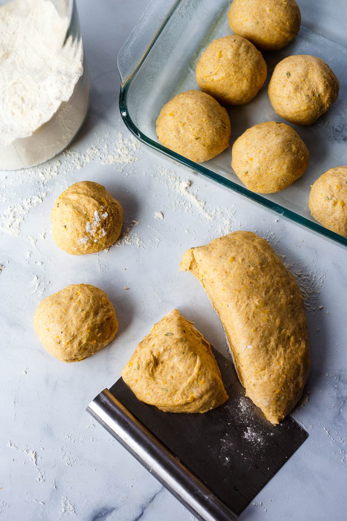 Shaping dinner roll dough into balls.