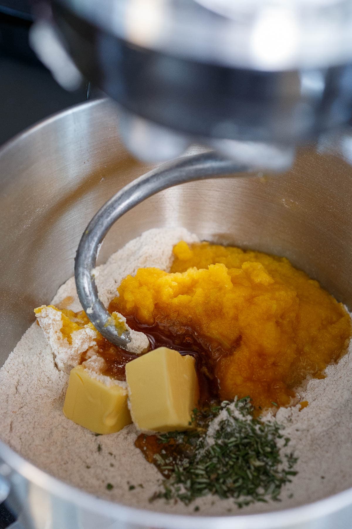 In a stand up mixer, flour, butter, butternut squash, rosemary, honey.