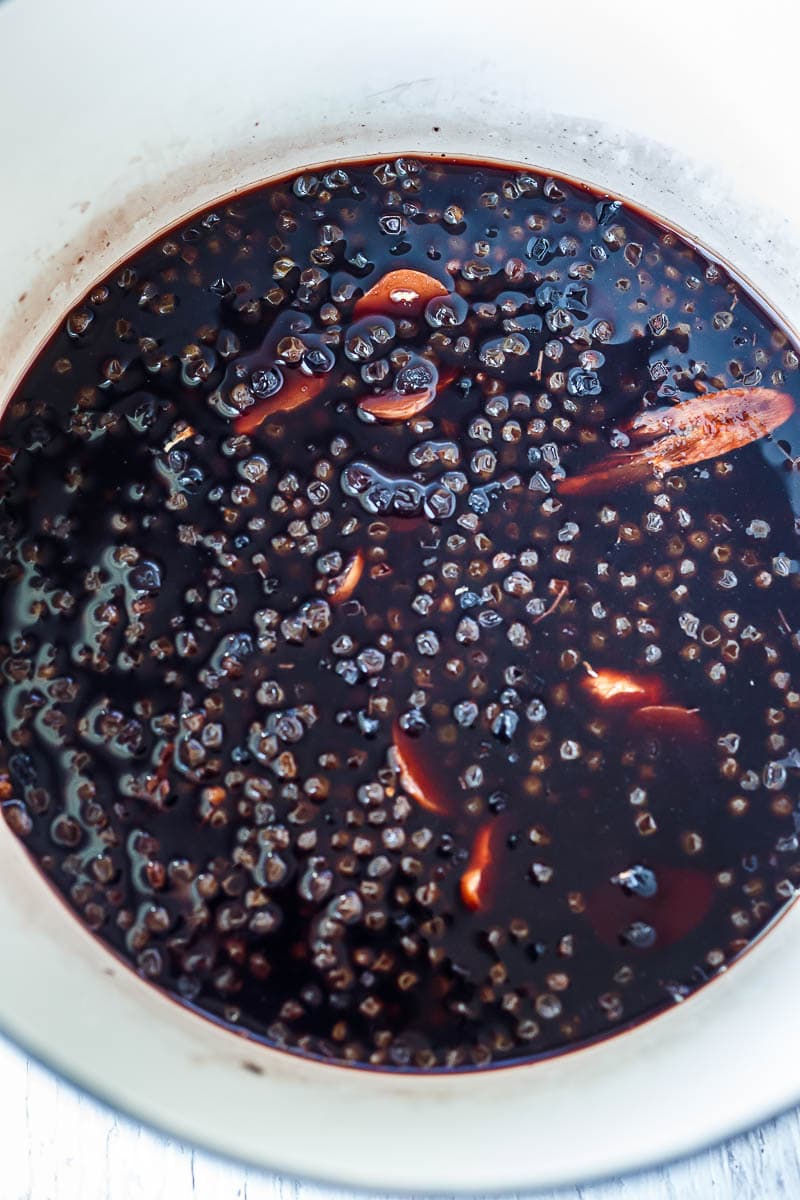 simmered elderberries in pot to make syrup.