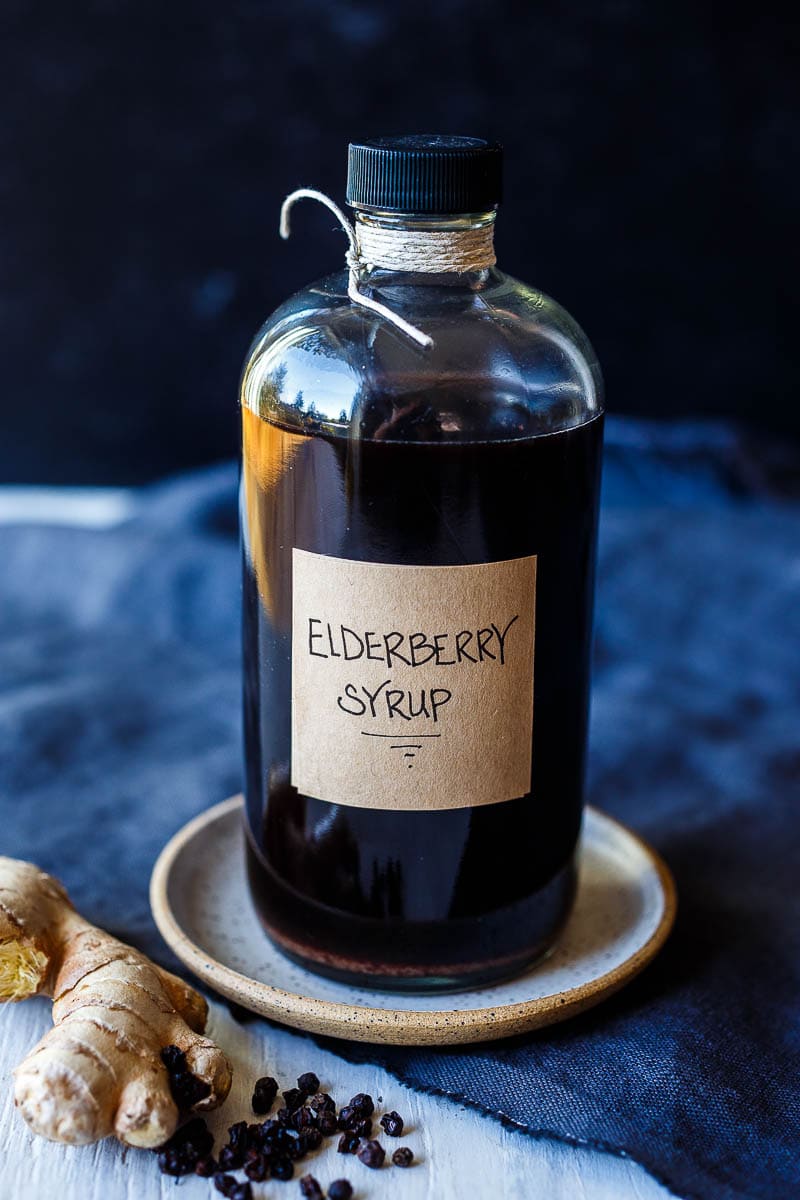 Homemade Elderberry Syrup in a glass jar with label. 