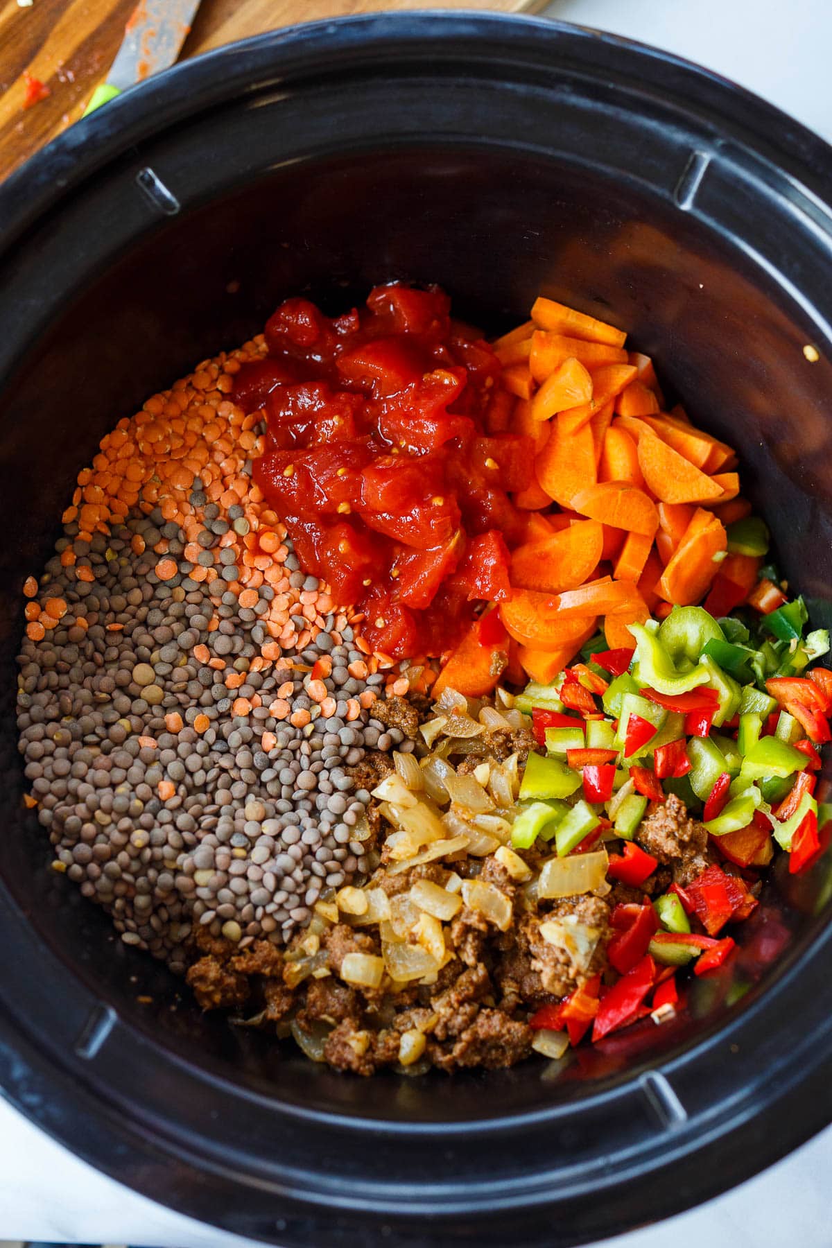 Cooking the chili in the crockpot, all the ingredients in the pot.