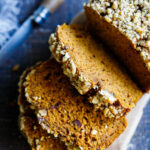 A delicious recipe for Pumpkin Bread with double the spices. This version is maple sweetened, with a crunchy nut topping, optional chocolate chips, and a moist tender crumb. Vegan-adaptable.