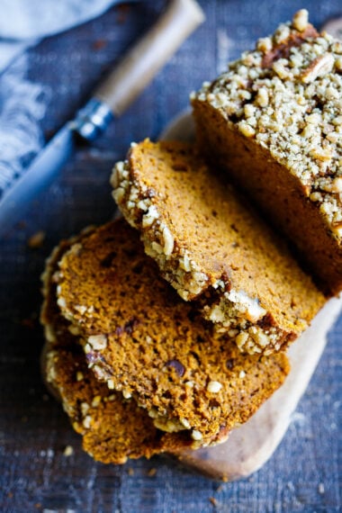 A delicious recipe for Pumpkin Bread with double the spices. This version is maple sweetened, with a crunchy nut topping, optional chocolate chips, and a moist tender crumb. Vegan-adaptable.