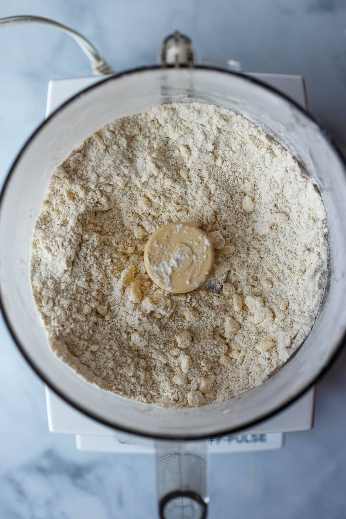 Food processor with crust ingredients.