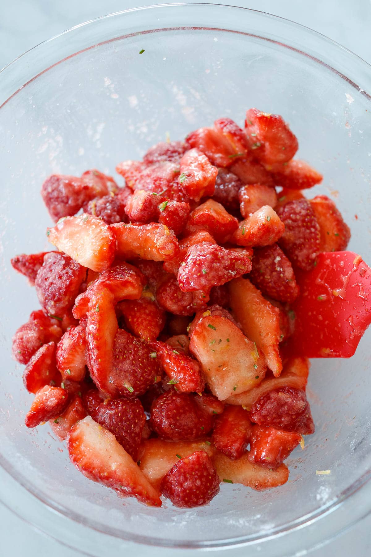 Strawberries in a bowl mixed with sugar.