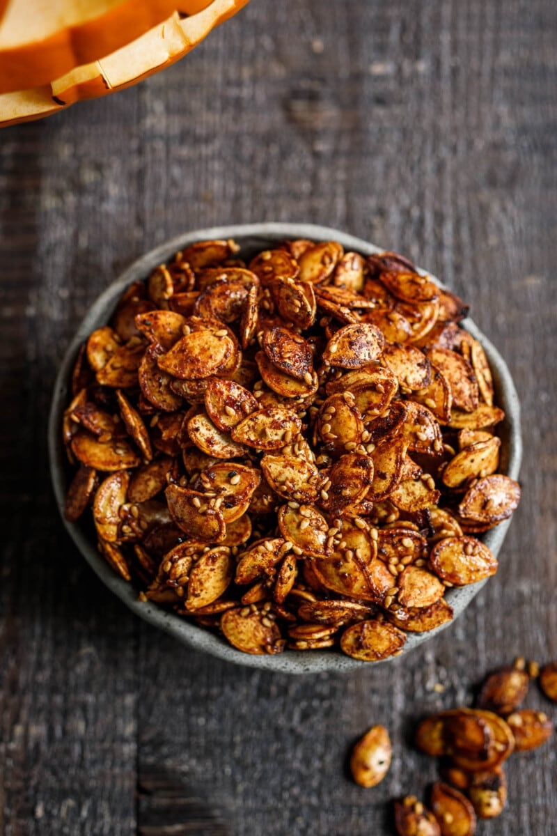 Sweet and savory Maple Roasted Pumpkin Seeds with smoked paprika, cumin and cinnamon. A tasty vegan snack, perfect for fall. 