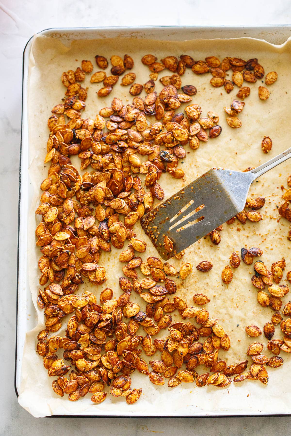 Sweet and savory, Maple Roasted Pumpkin Seeds with smoked paprika, cumin, cayenne and cinnamon. A tasty vegan snack, perfect for fall. 