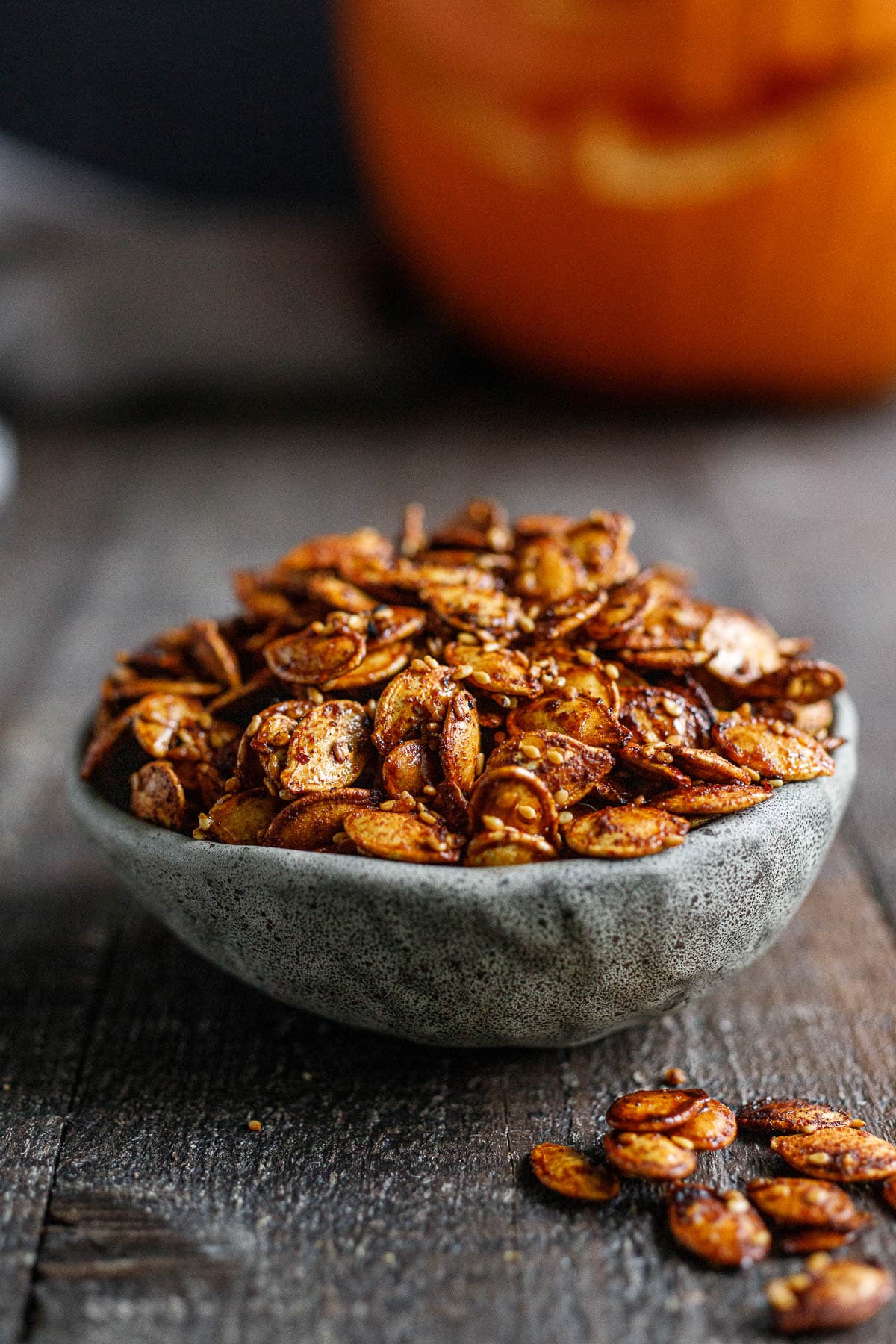 Sweet and savory Maple Roasted Pumpkin Seeds with smoked paprika, cumin and cinnamon. A tasty vegan snack, perfect for fall. 