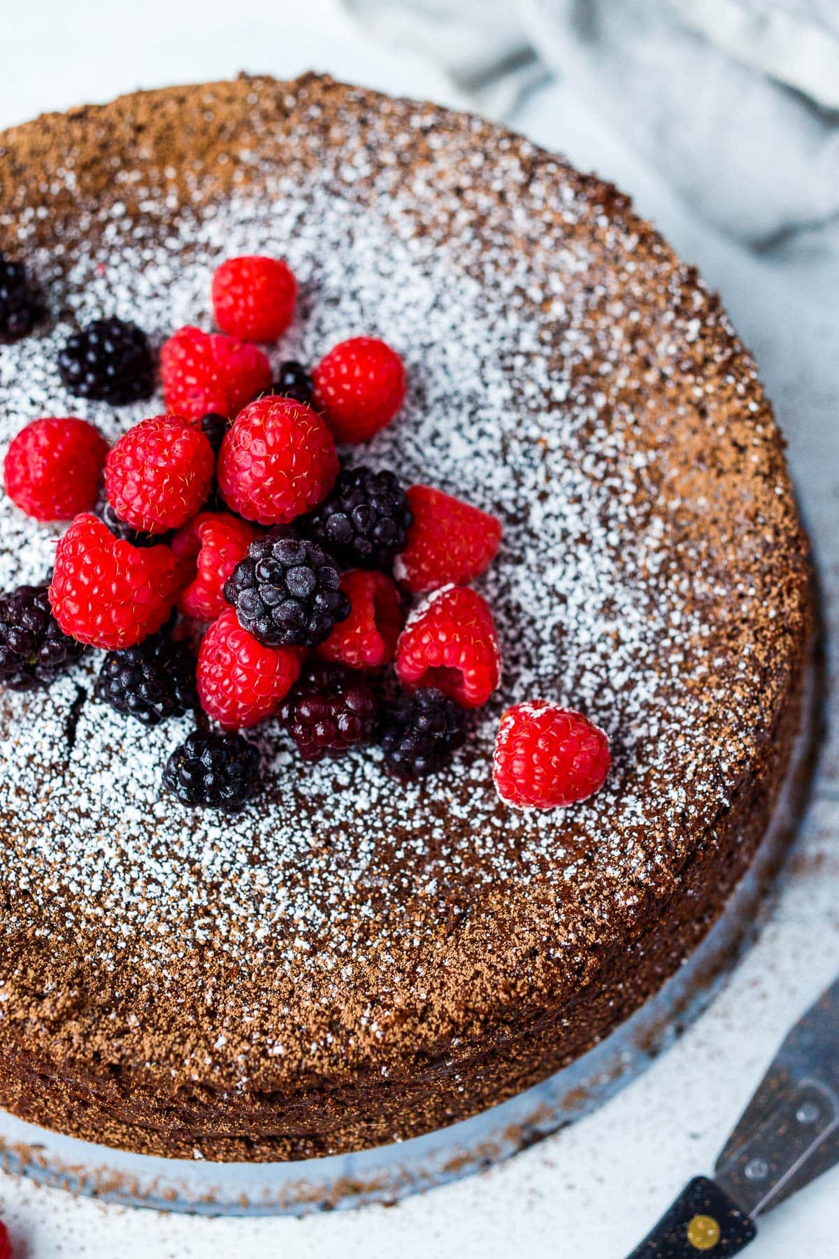 a whole chocolate torte with berries. 