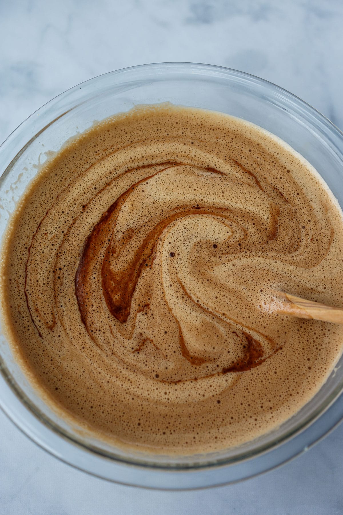 Mixing chocolate into the egg mixture.