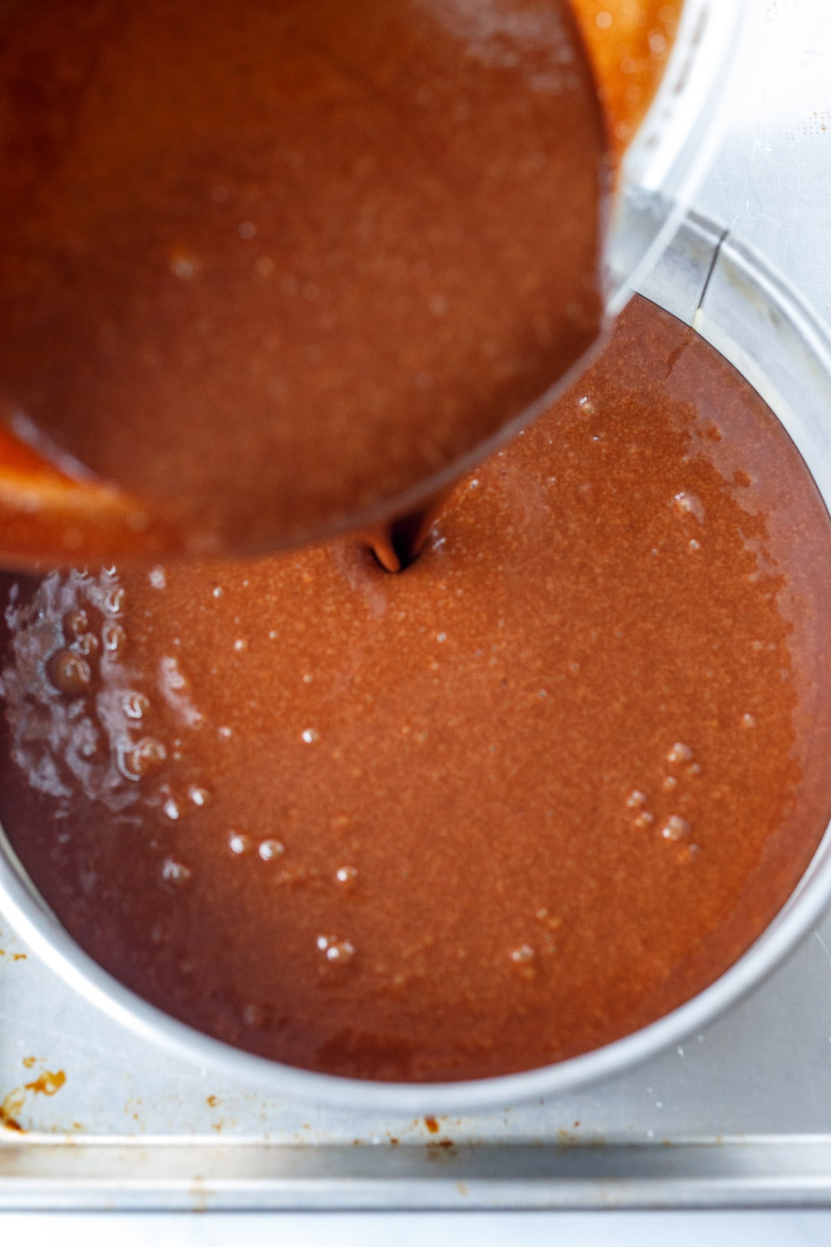 Pouring the chocolate torte batter into the pan.