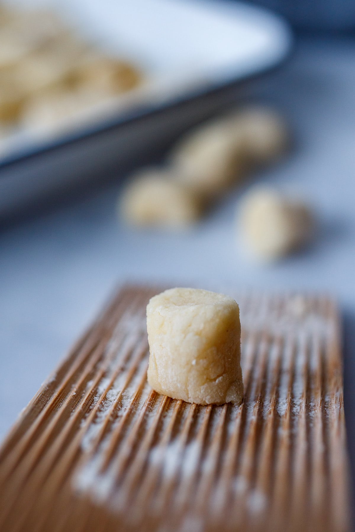 Shaping gnocchi on the pressing board.