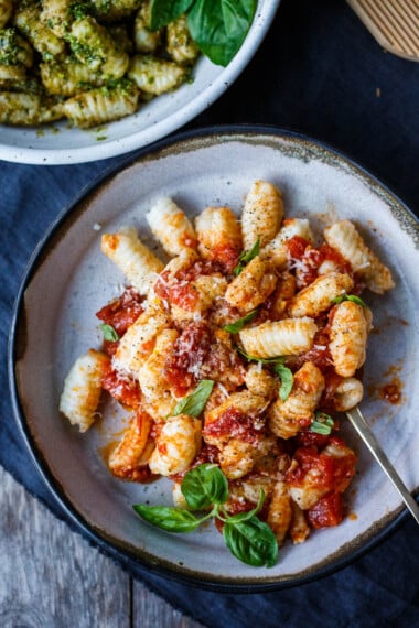 Homemade potato gnocchi! Just four simple ingredients result in the dreamiest little dumplings. These little pillows of joy are easy to make and much more delicious than store-bought. From baked and sautéed to boiled you'll find so many ways to use them!