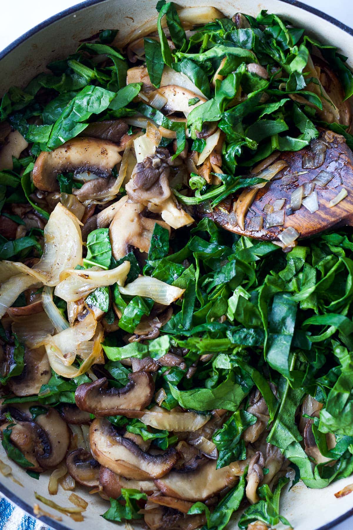 Adding in fresh spinach.