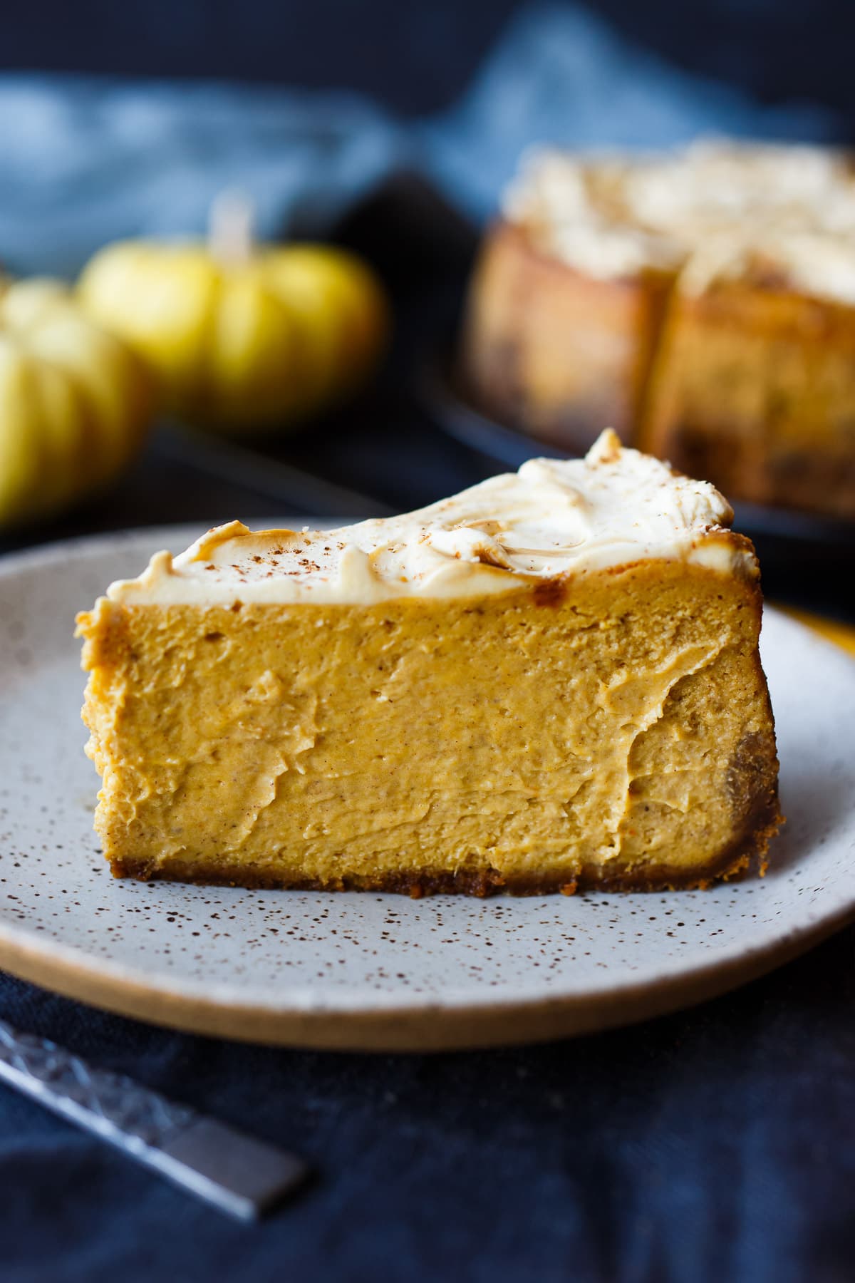 Gingery Pumpkin Cheesecake with a crispy gingersnap crust and luscious, creamy pumpkin filling. Easy and delicious! 