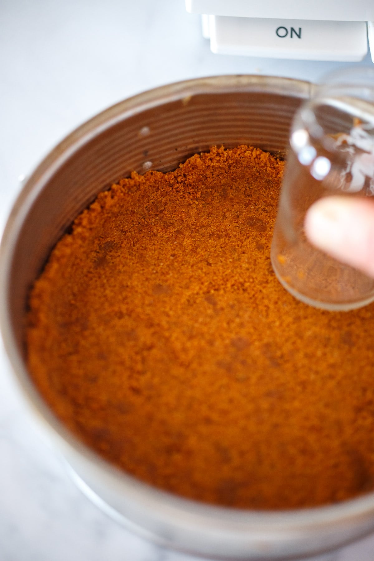 Pressing the crust into the pan.