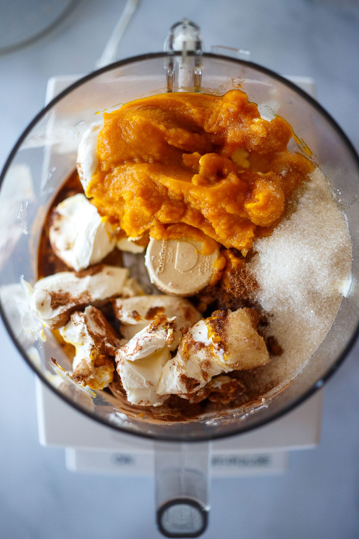 Pumpkin cheesecake filling ingredients in the food processor.