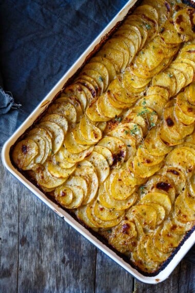 These easy Scalloped Potatoes are made with simple ingredients and just 25 minutes of hands-on time, before baking in the oven. Tender and creamy with a golden crispy top, they are perfect for weeknights or the holiday table.