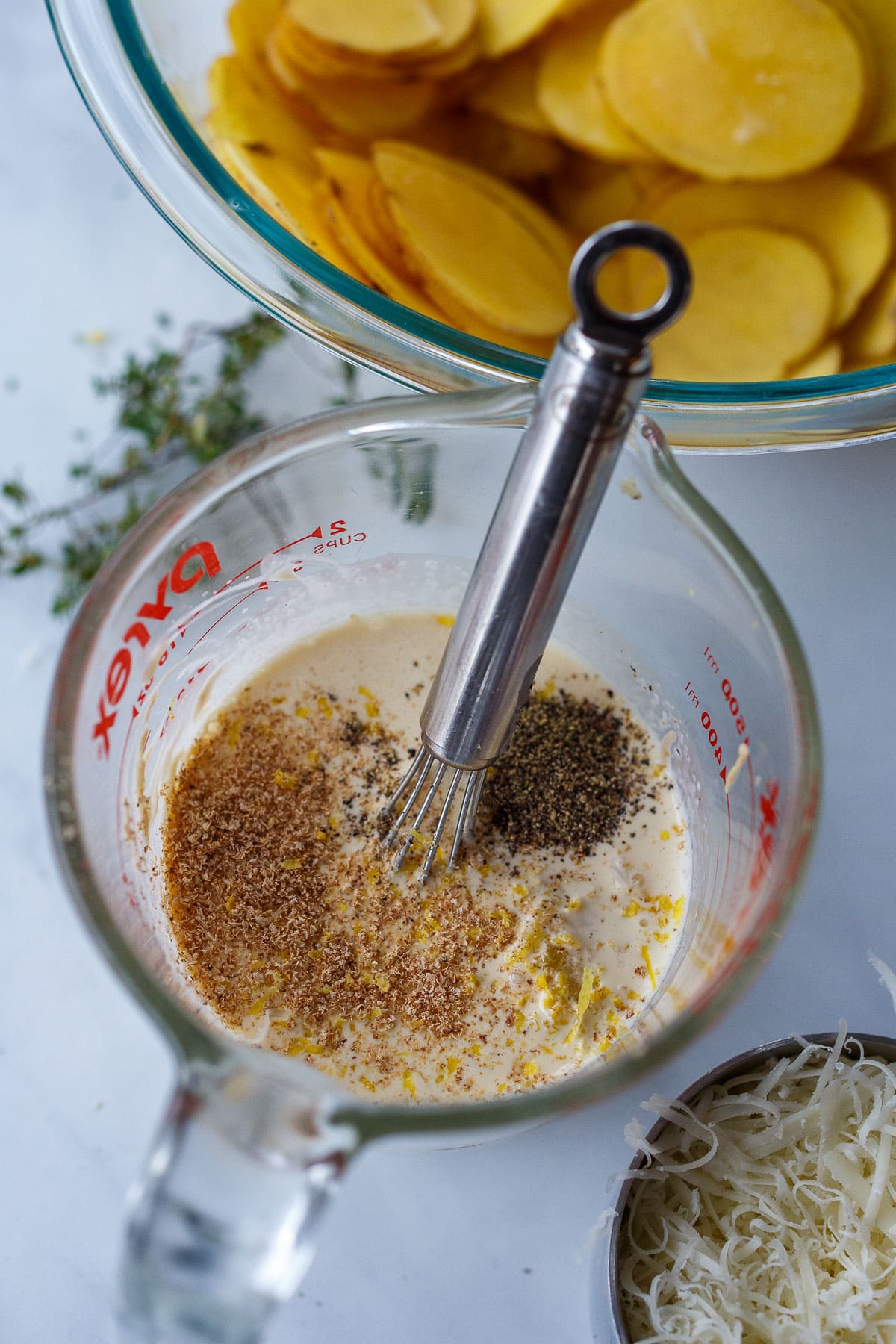 Cream stirred with pepper, nutmeg, thyme, lemon zest and salt.