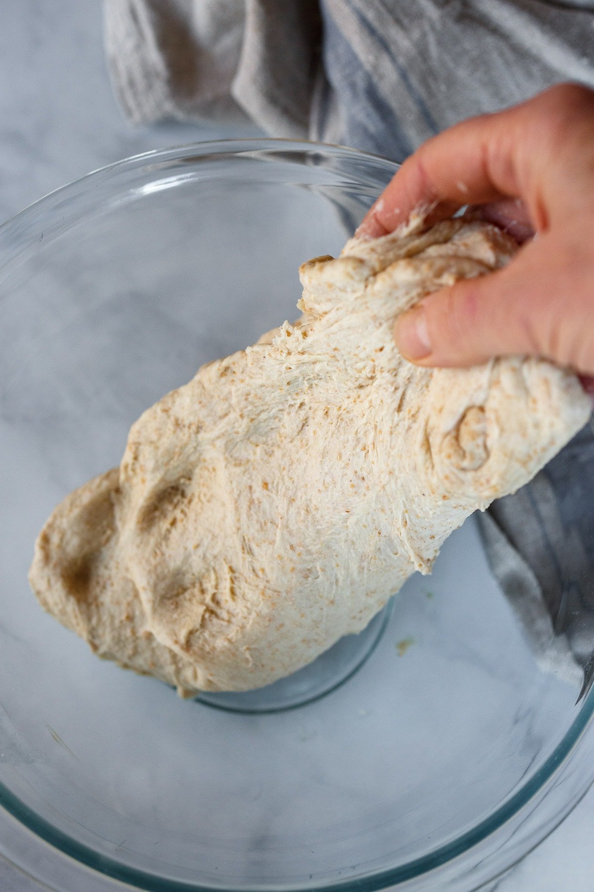 Stretching and folding the dough.