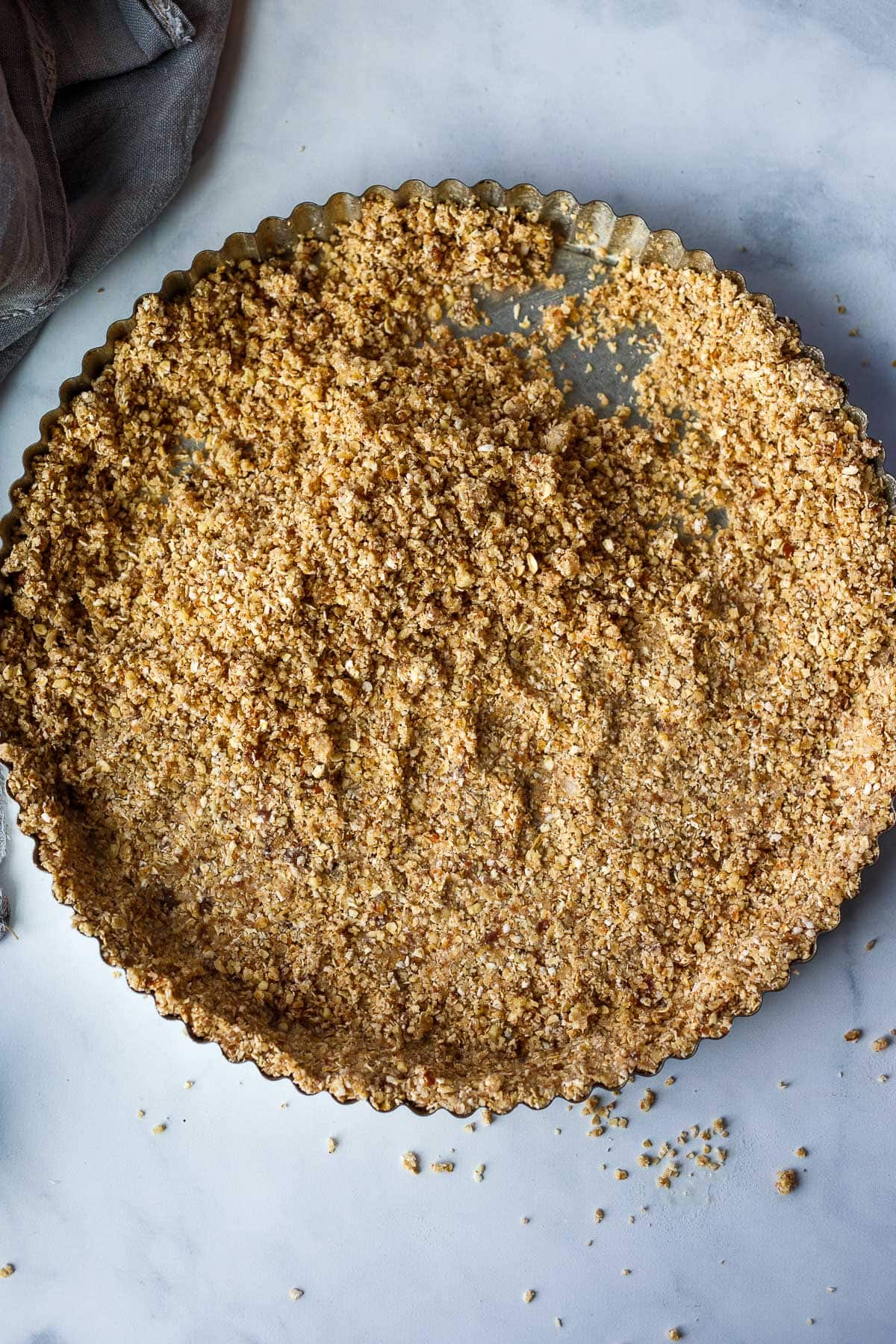 Pressing the crust into the tart pan.