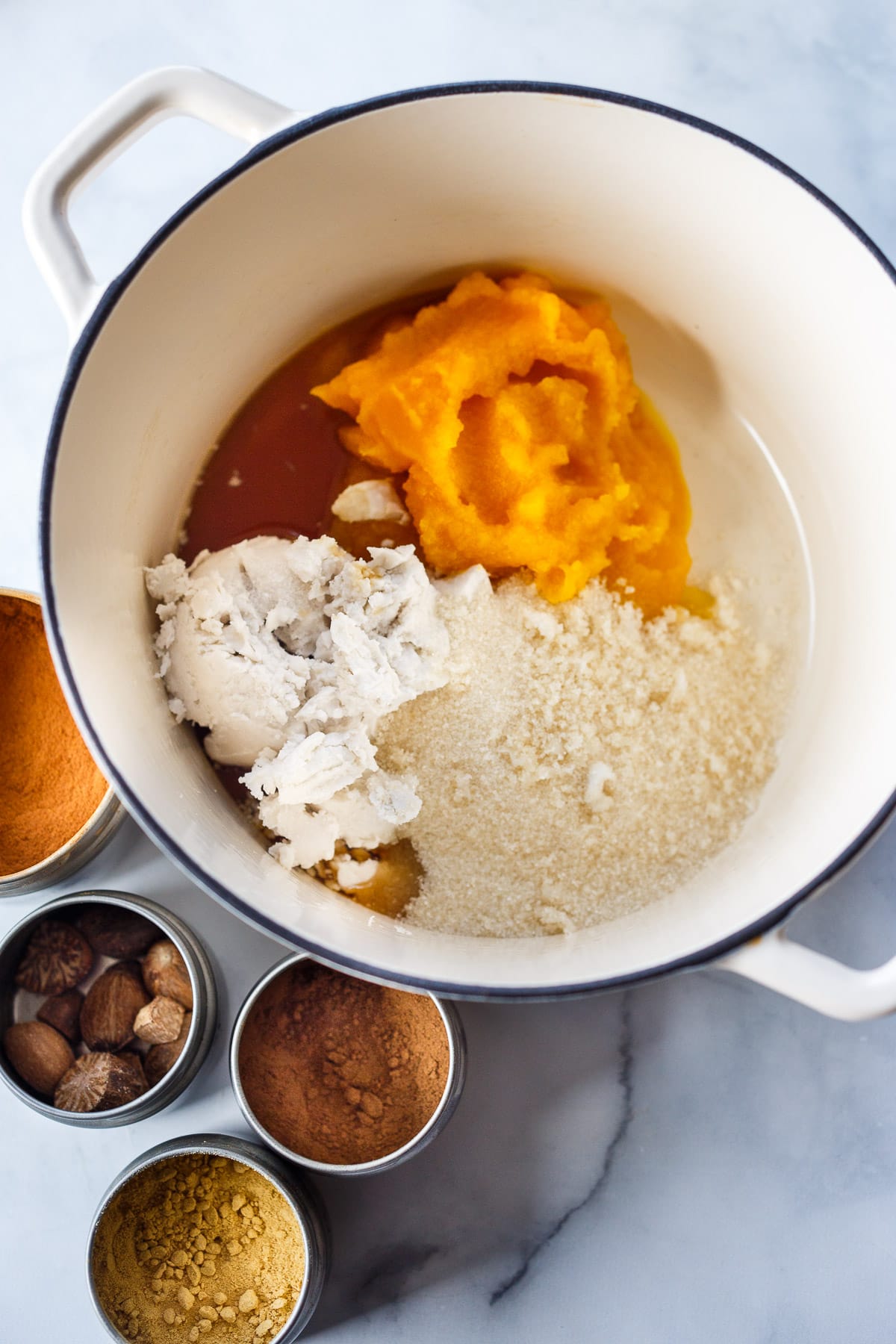 In a stock pot, pumpkin, sugar, maple, coconut cream, and spices.