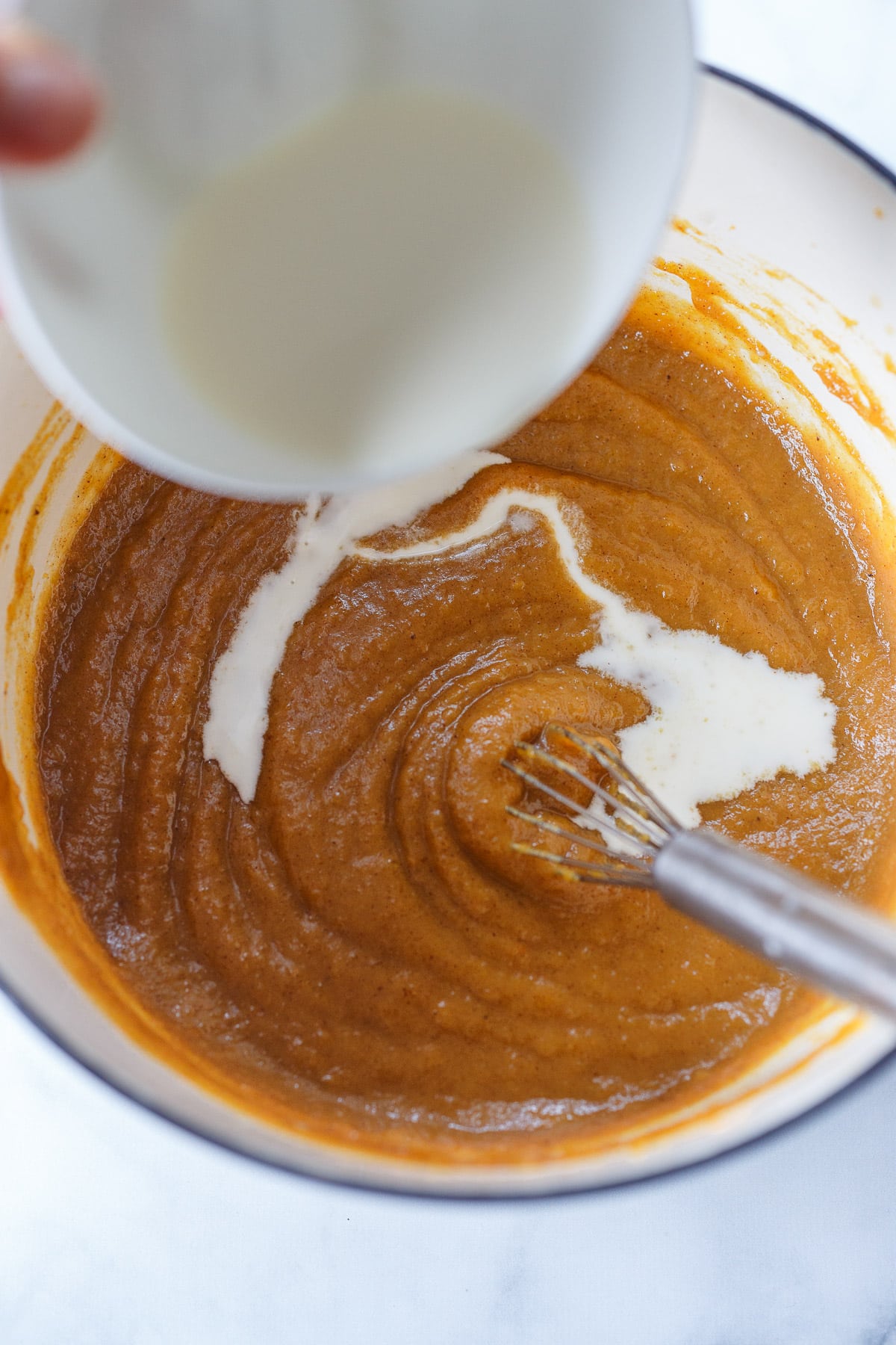 Pouring cornstarch into pumpkin mixture.