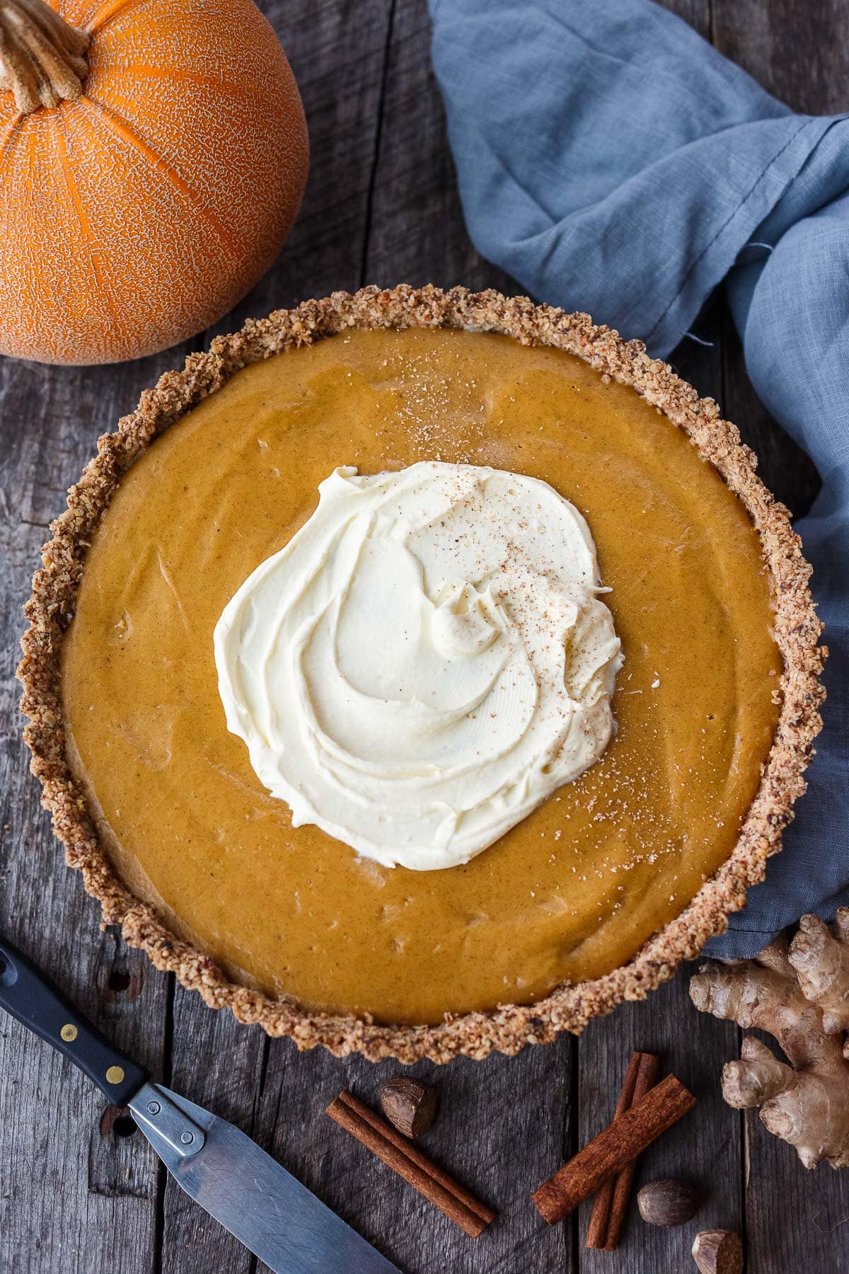 A decadent Vegan Pumpkin Tart with a smooth caramely pumpkin filling in a tender pecan oat crumb crust. Richly spiced, easy to make, and freezes beautifully. Perfect for the holidays!