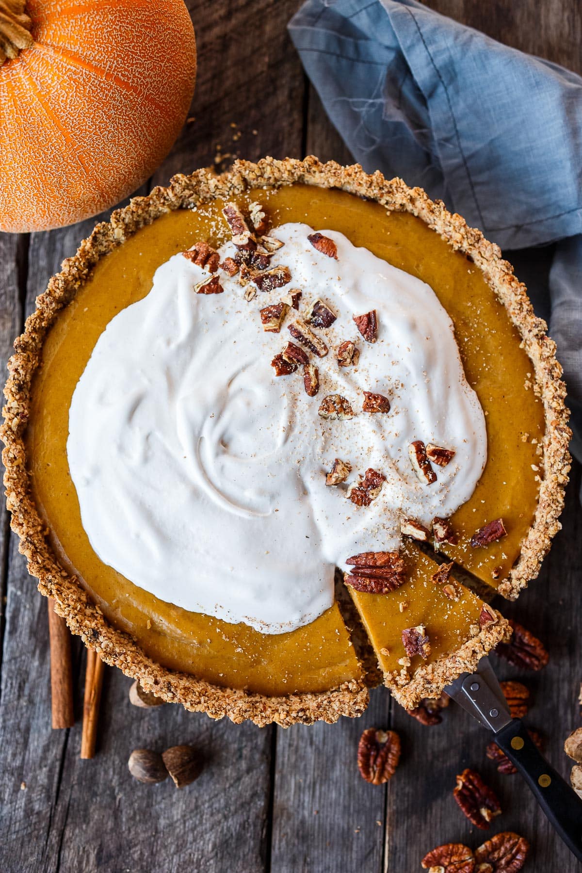 A decadent Vegan Pumpkin Tart with a smooth caramely pumpkin filling in a tender pecan oat crumb crust. Richly spiced, easy to make, and freezes beautifully. Perfect for the holidays!