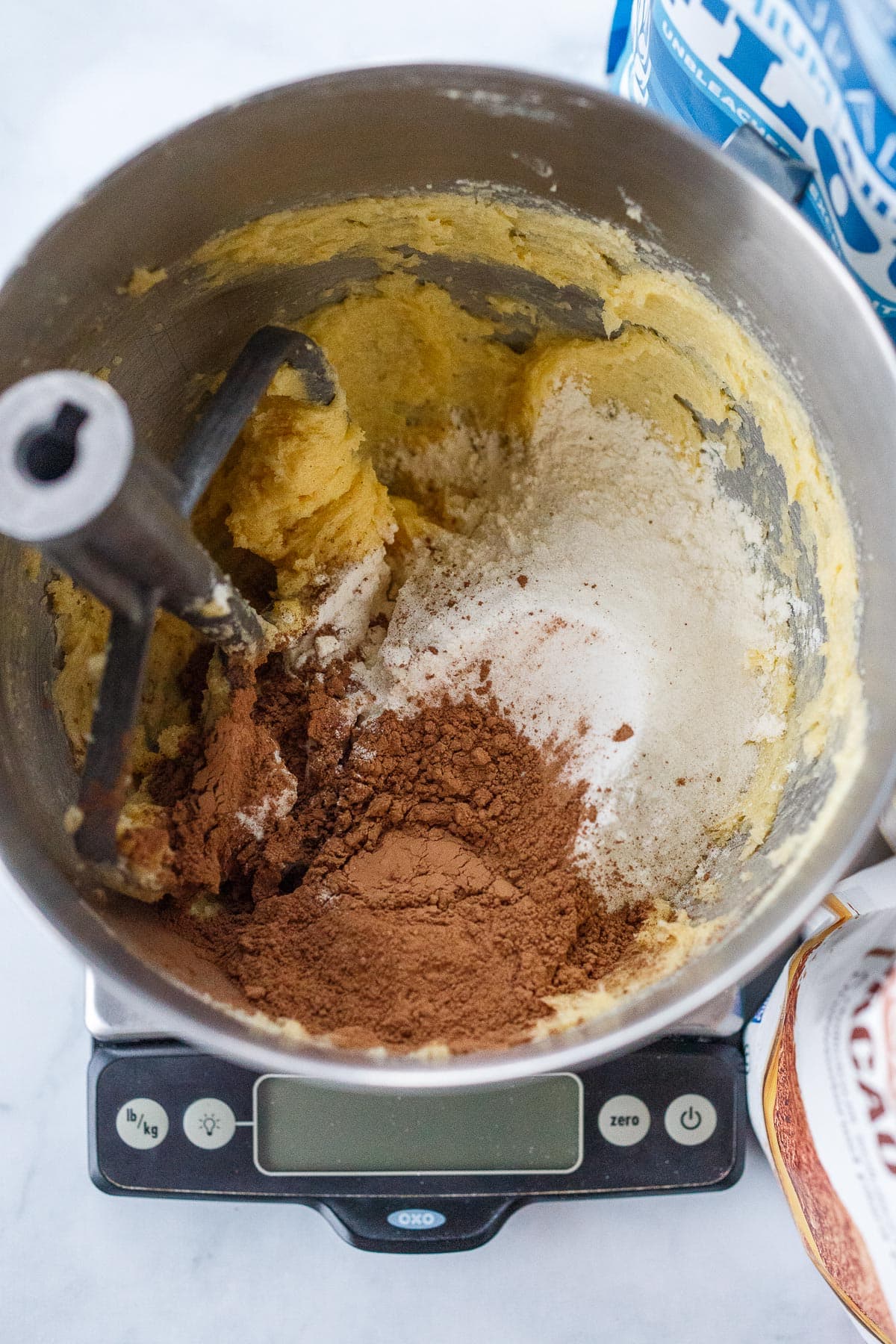Flour and cacao powder added to whipped butter and sugar.