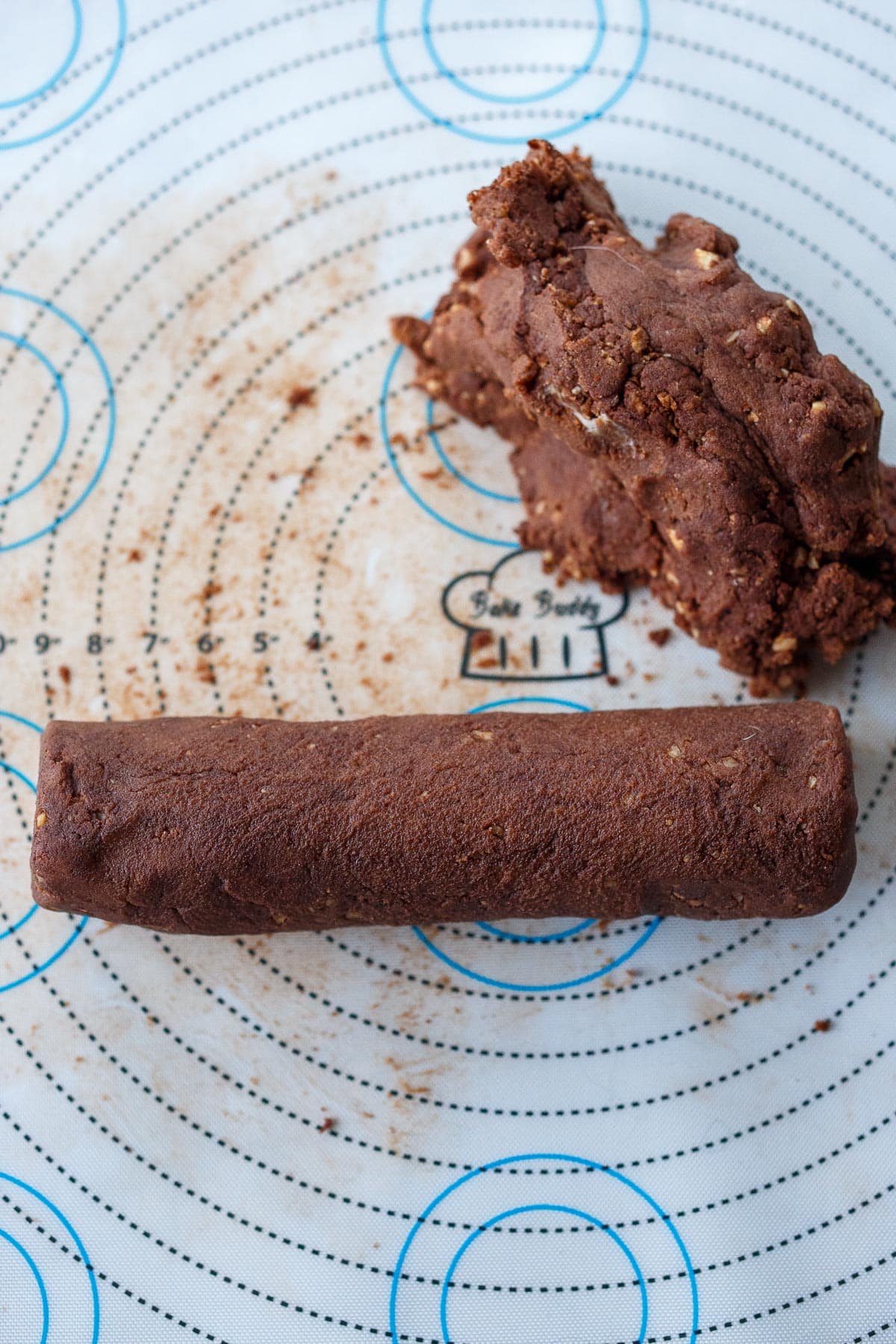 Rolling cookie dough into logs.