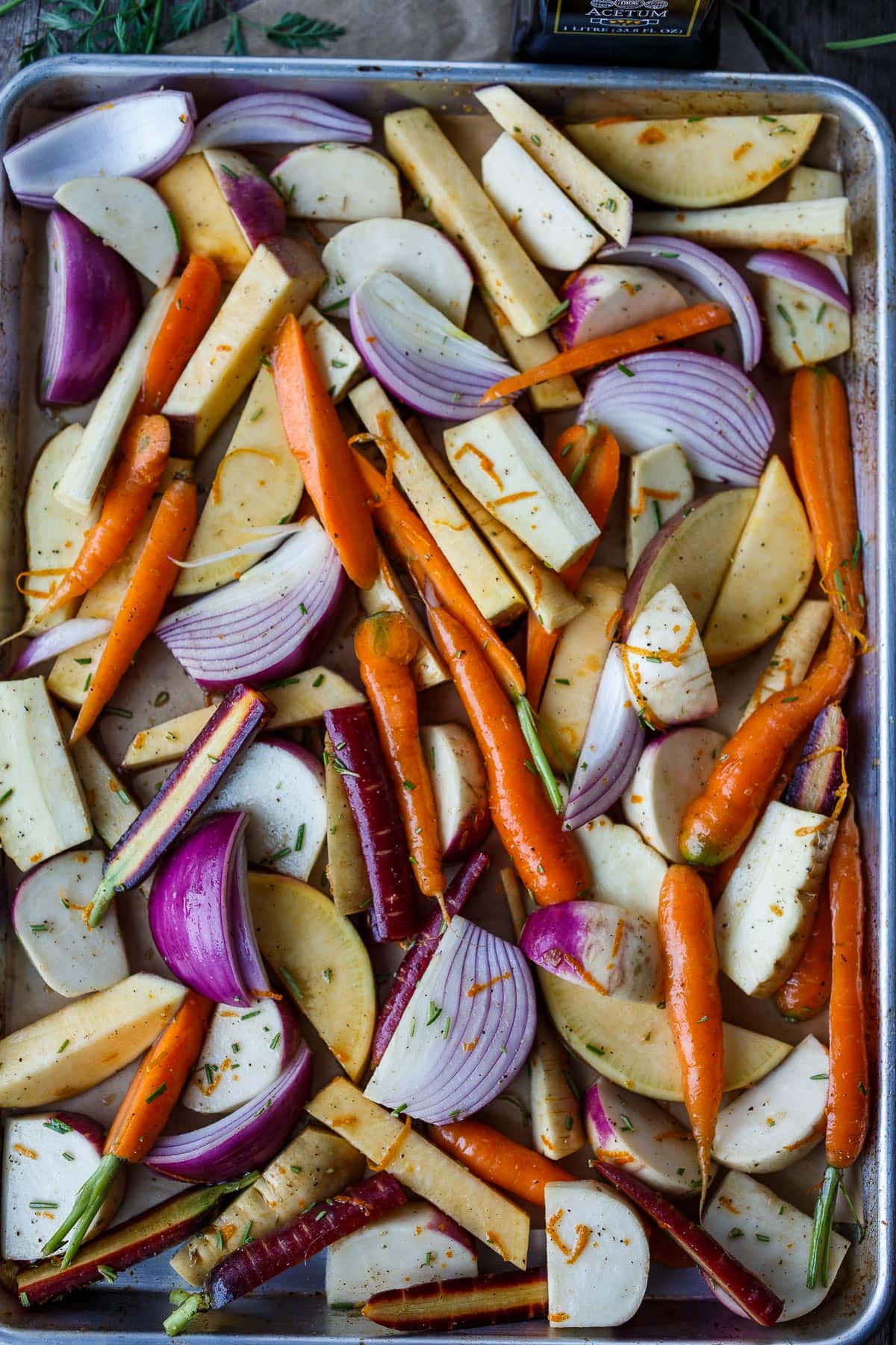 Root vegetables layed out on a tray ready to bake.