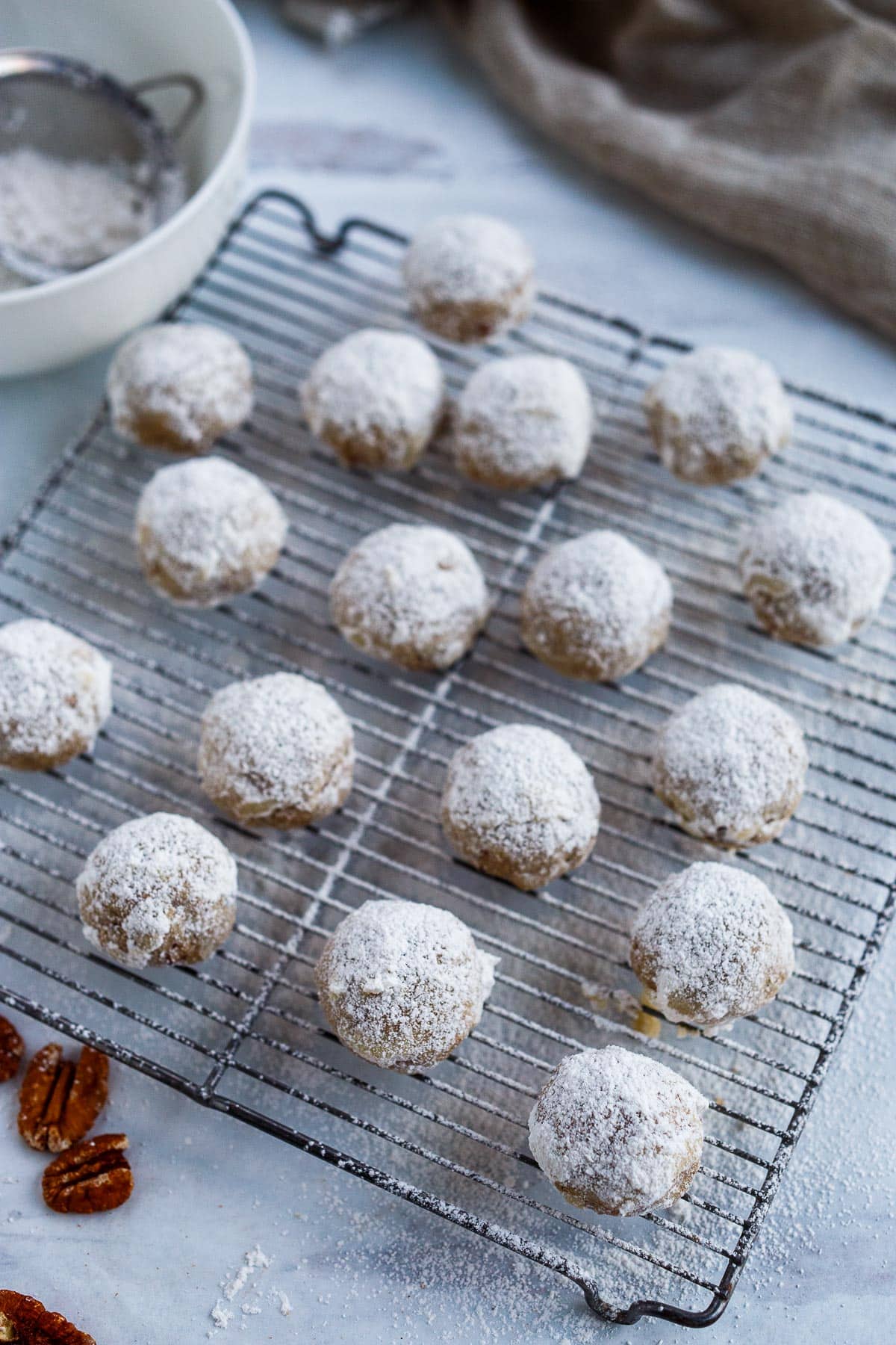 Irresistible Snowball Cookies enhanced with earthy rye flour and toasted pecans are melt in your mouth delicious! Easy to make, they stay fresh for days and make the perfect gift. Known also as Mexican Wedding Cookies and Russian Tea Cakes.