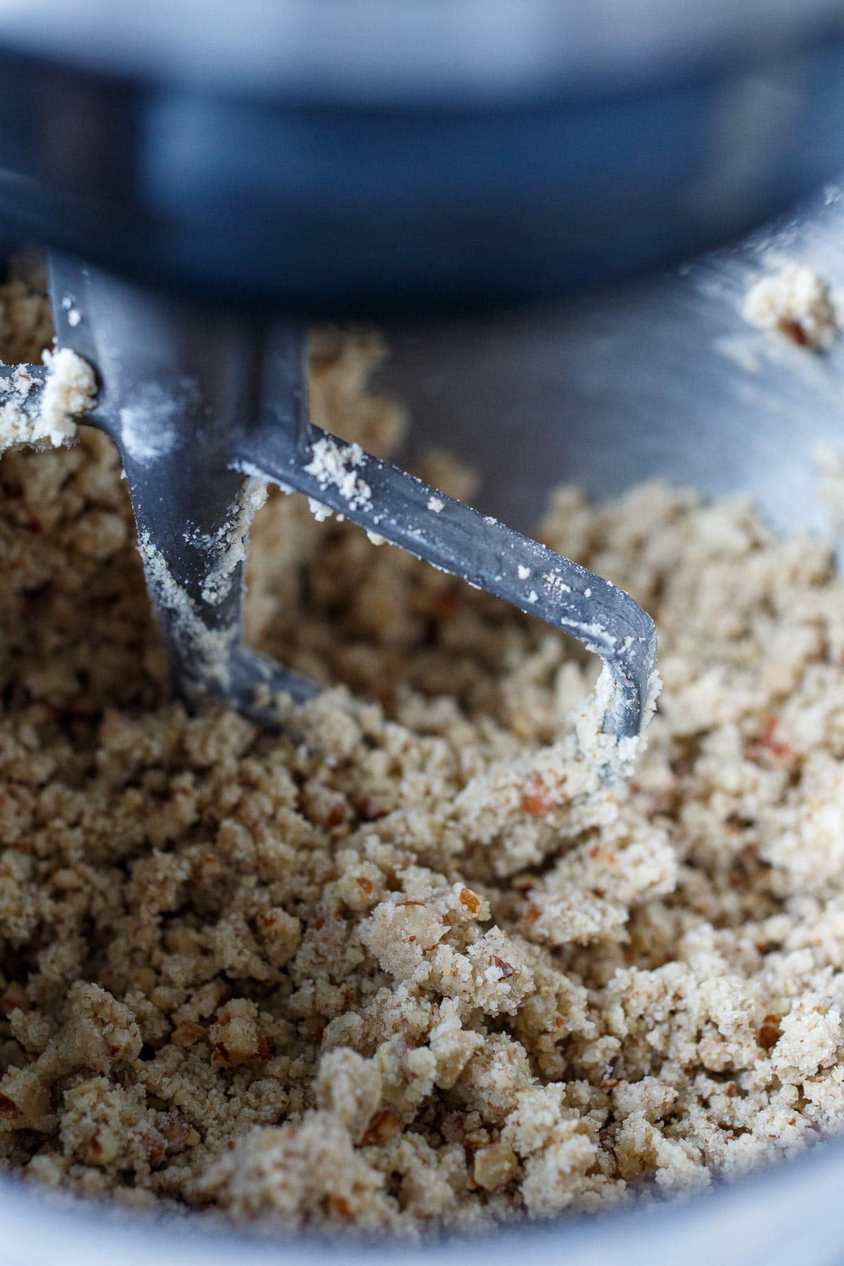 Crumbly cookie dough in the mixer.