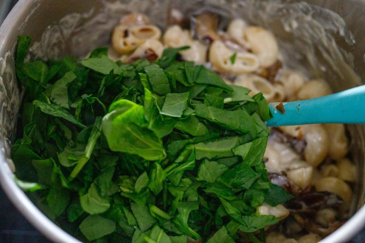 Stirring in a couple handfuls of chopped spinach.