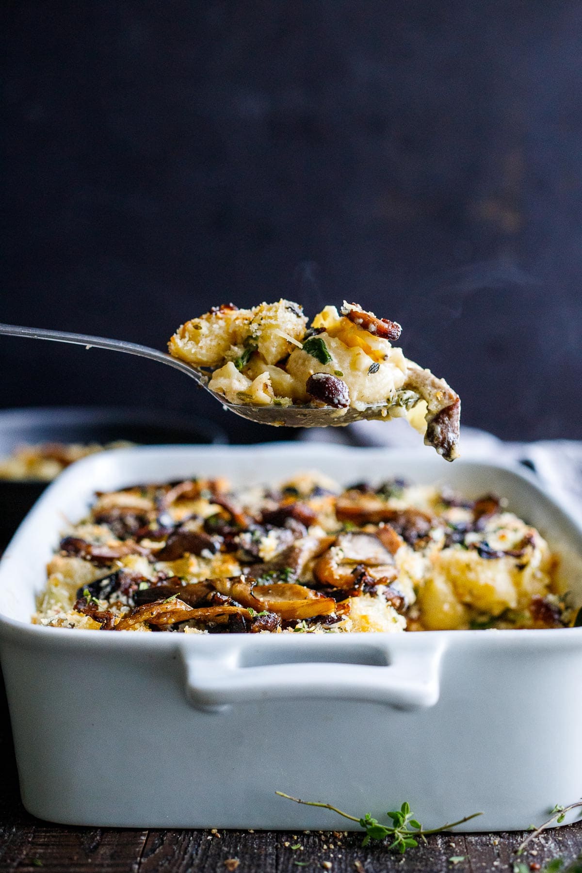 A spoonful of truffle Mac and cheese being lifted from the pan. 