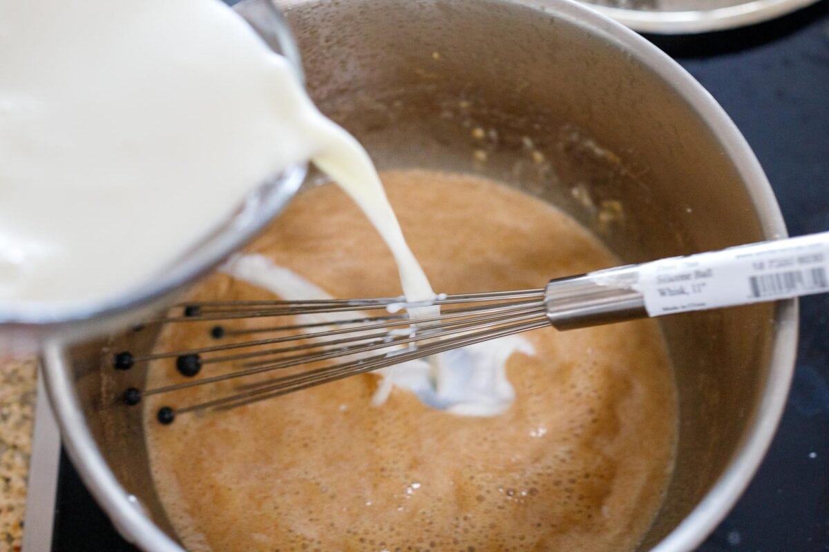 Adding milk to the flour butter mixture.