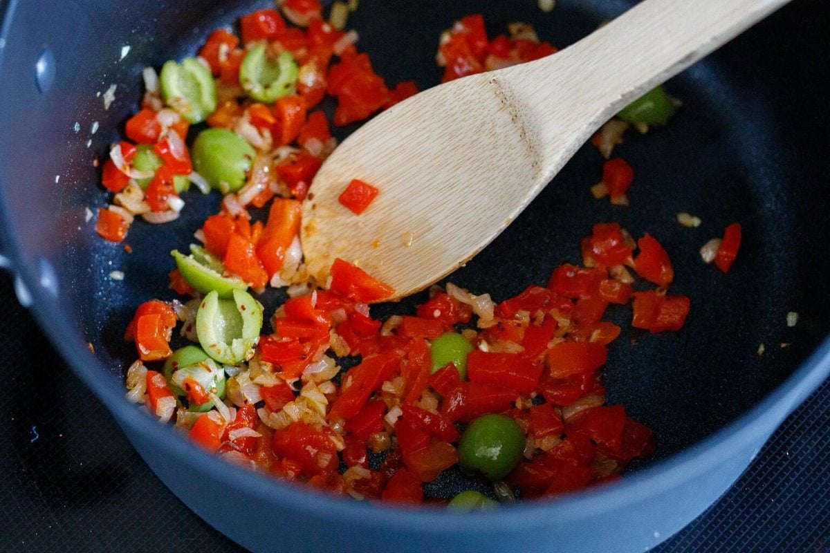 saut&eacute;ing onion, pepper and wolves