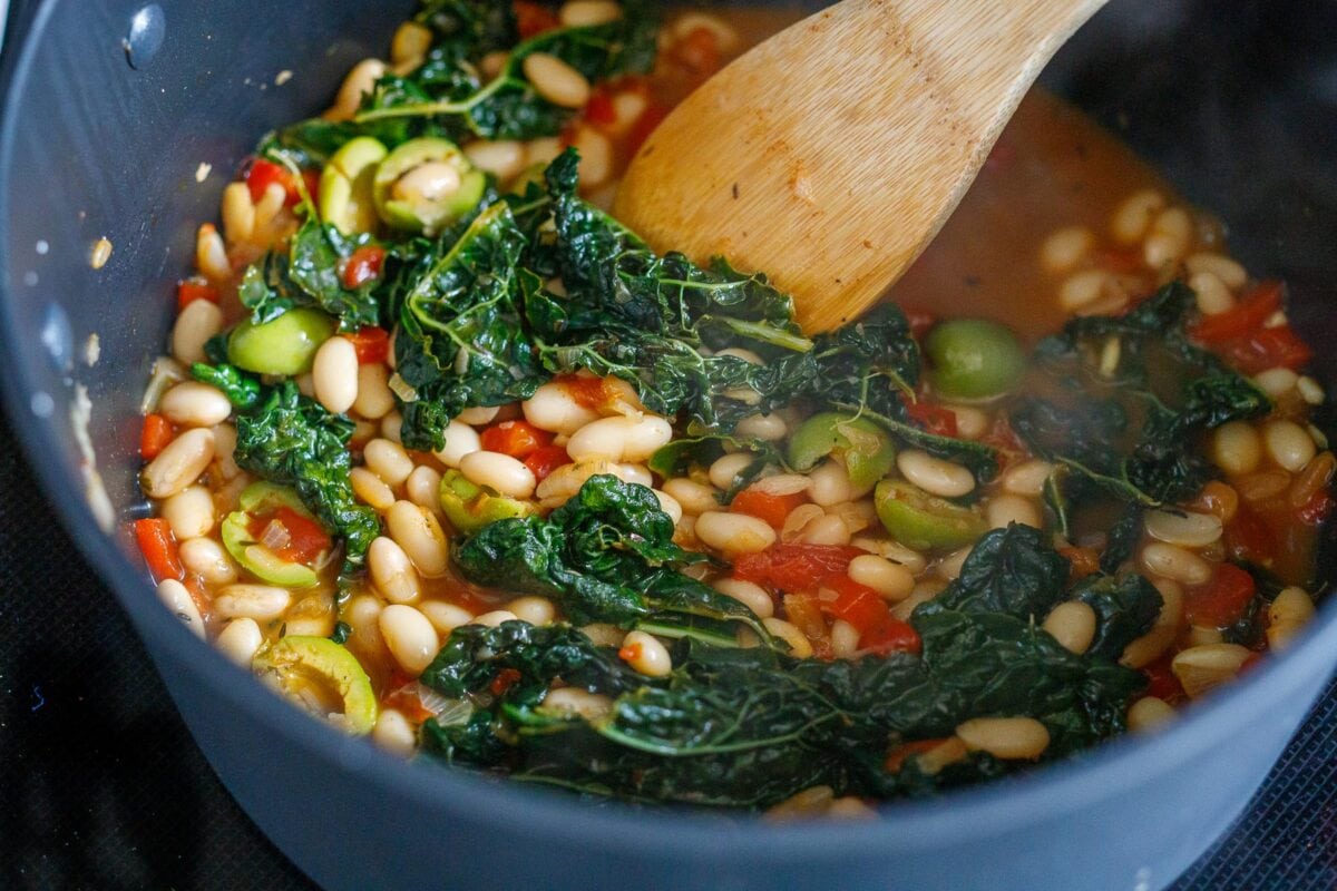 stirring the  the brothy beans 