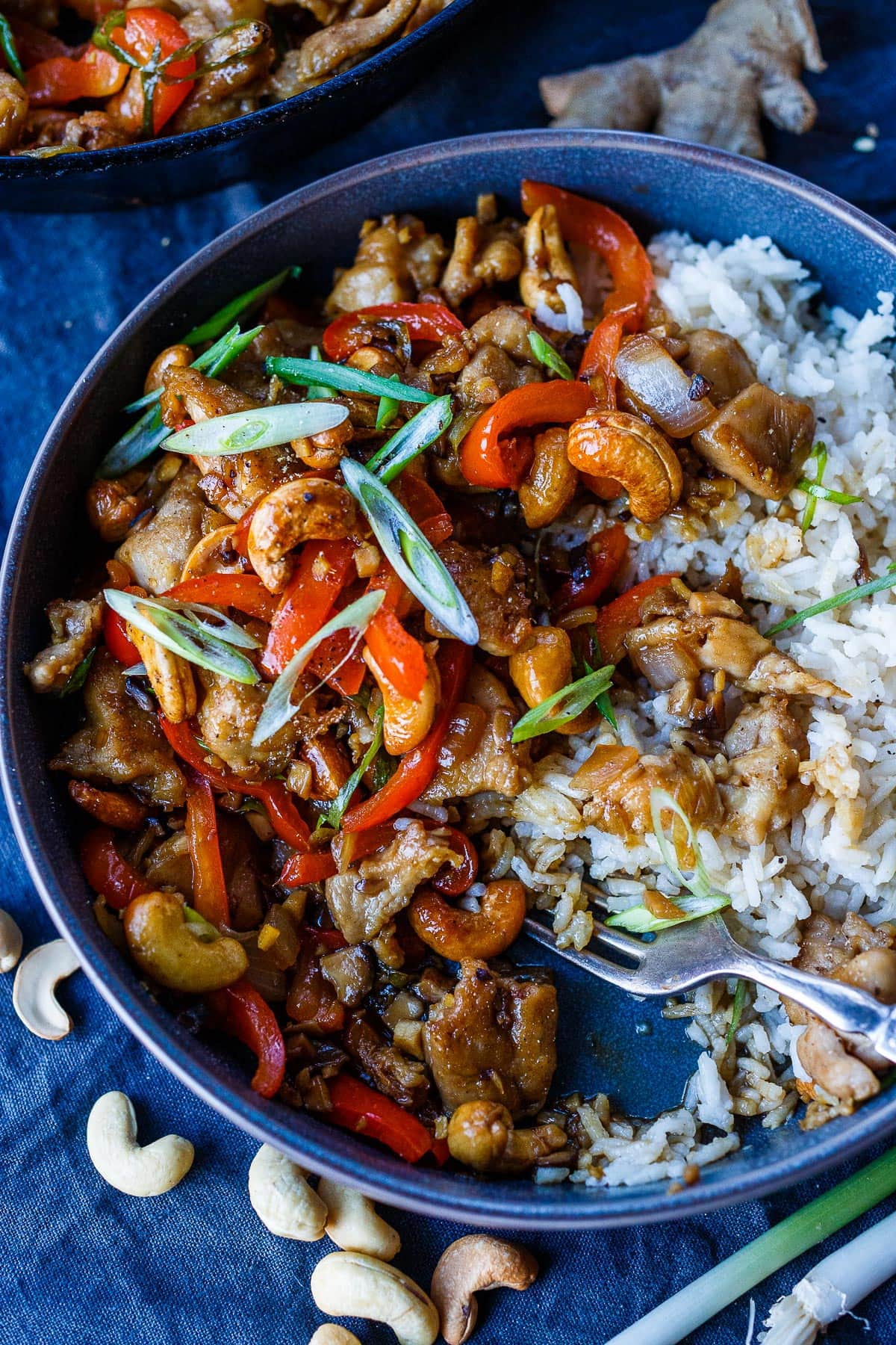 Cashew Chicken in a bowl with rice and fork.