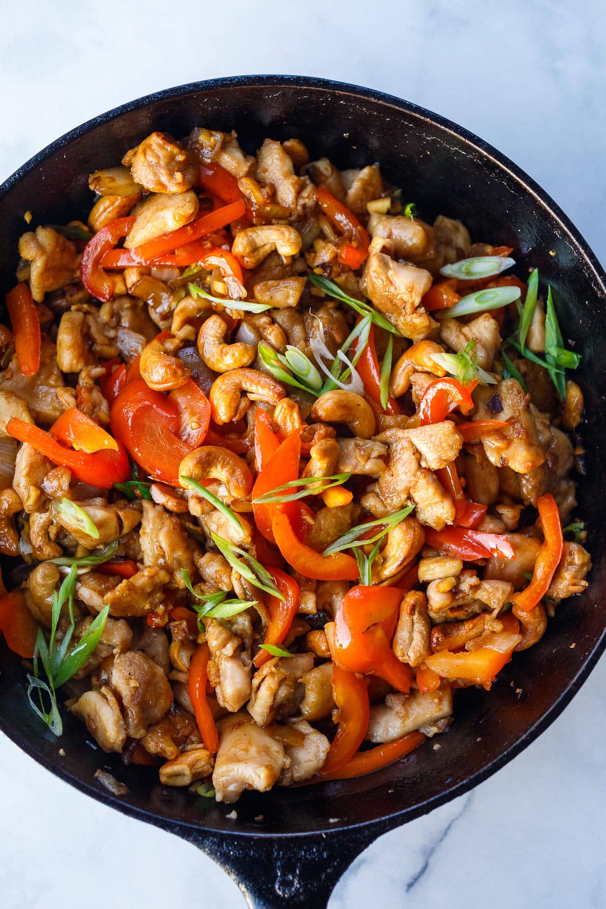 Stir fried cashew chicken in a pan.