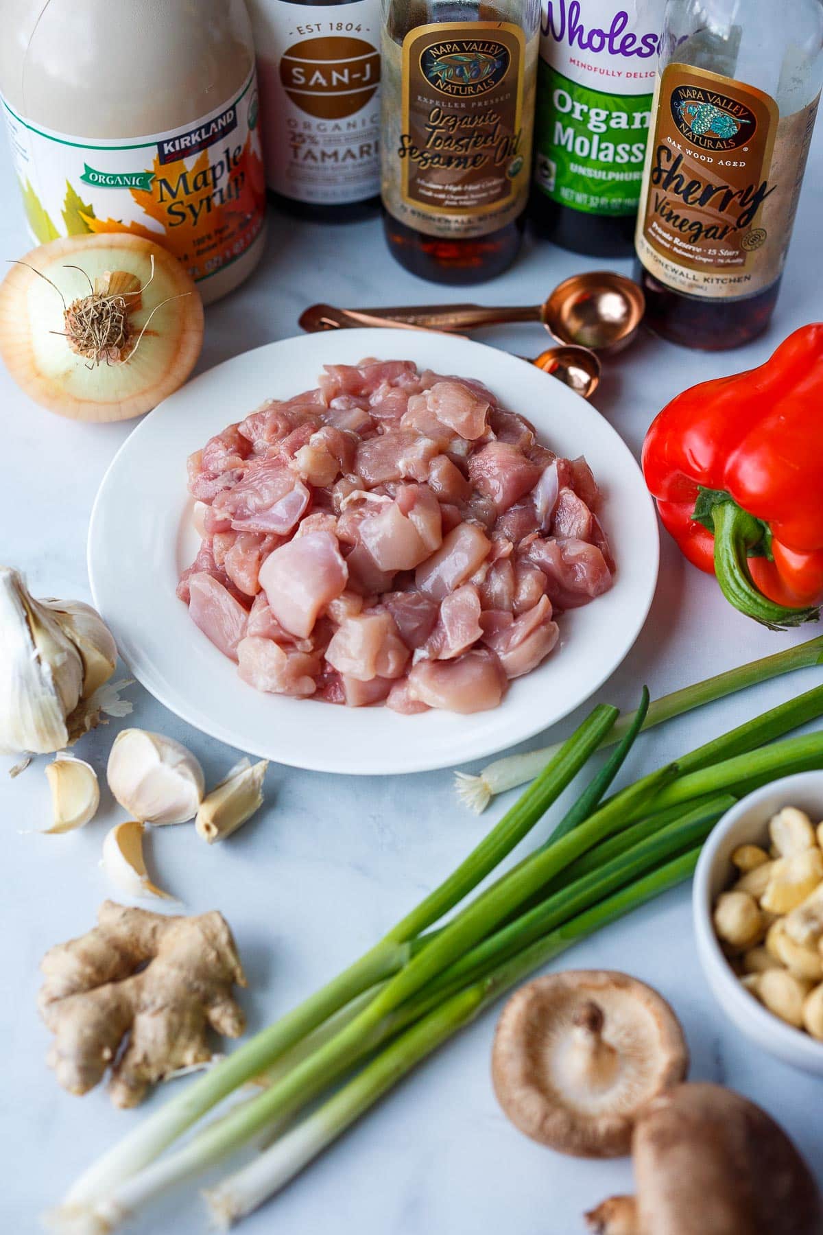 Cut chicken and ingredients for cashew chicken.