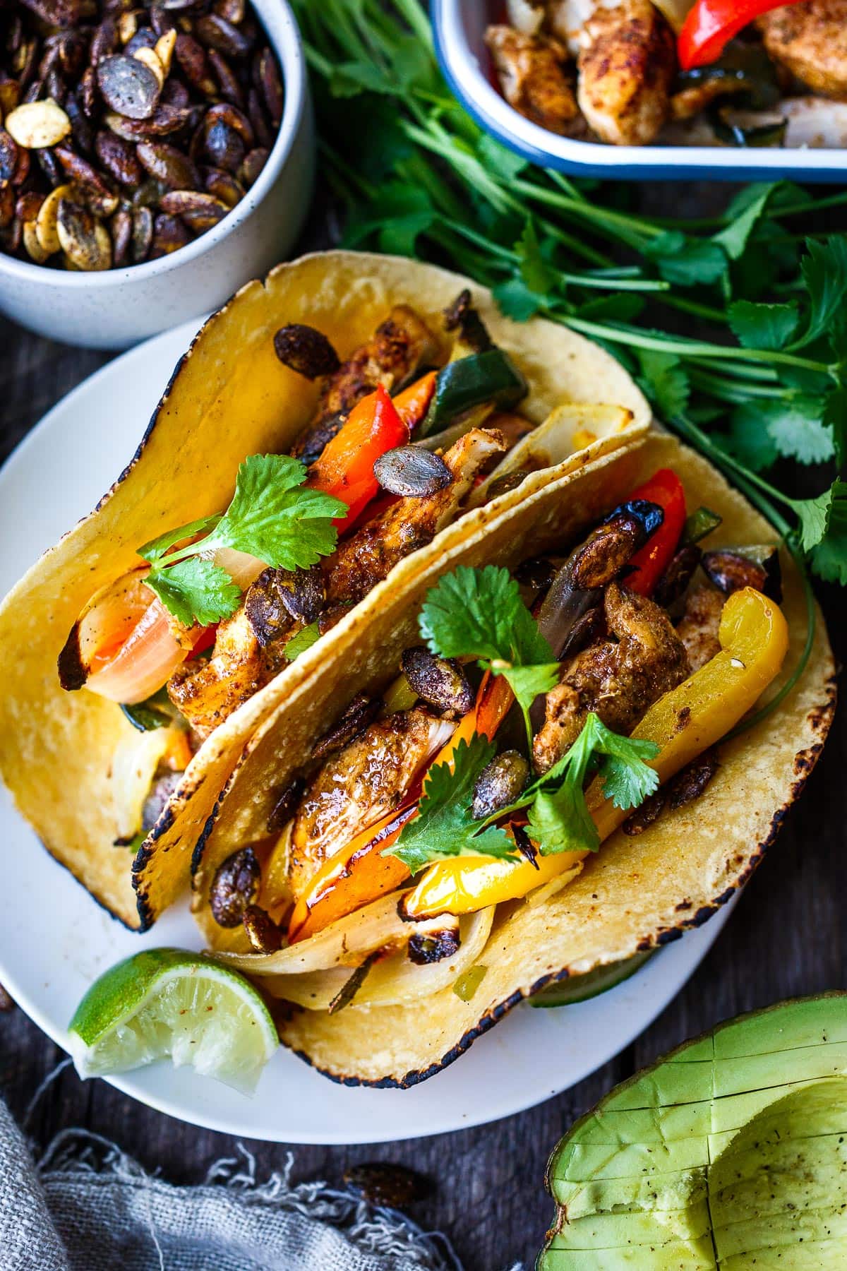 Sheet Pan Chicken Fajitas are a quick easy one-pan dinner! Deliciously marinated chicken and veggies are roasted until tender & succulent.