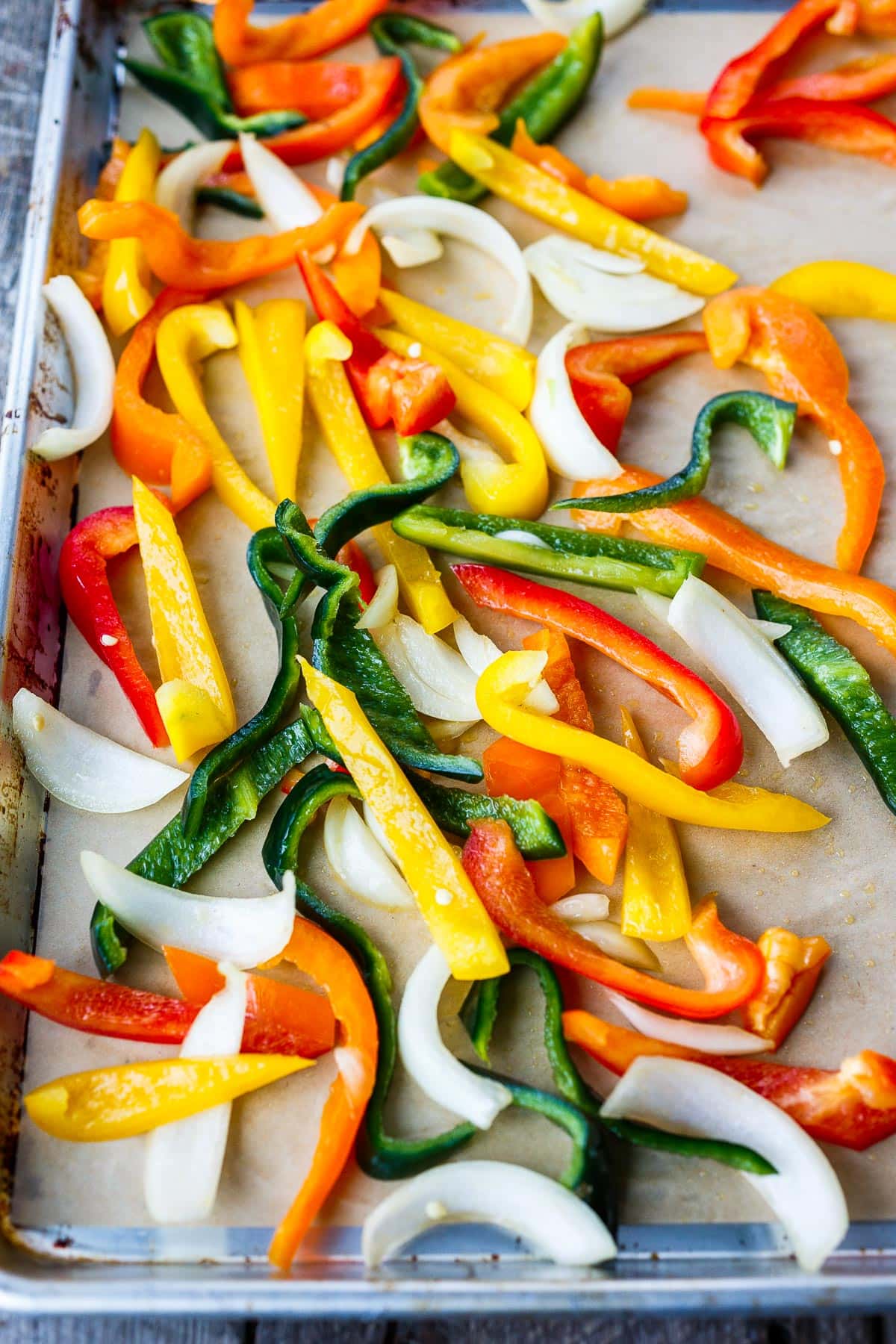 Peppers and onions on a baking sheet.