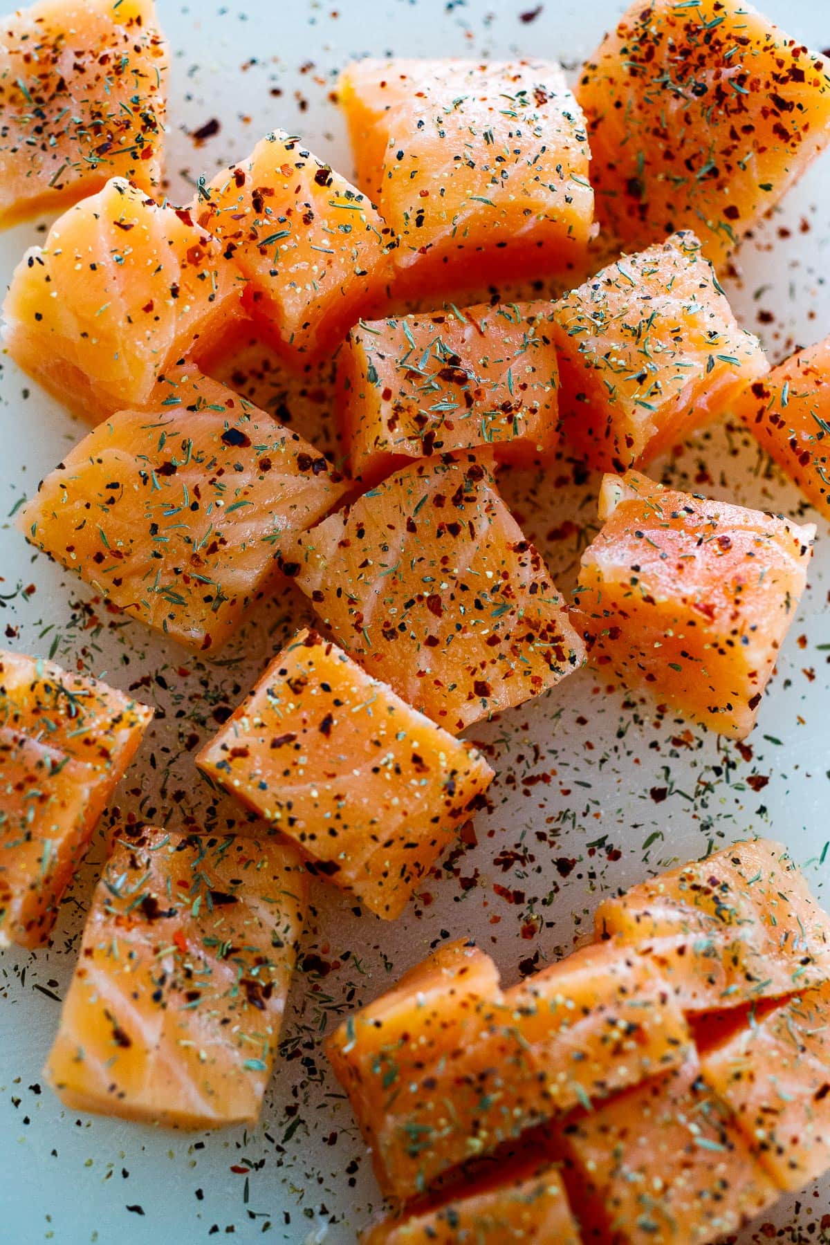 Salmon cut into bite-sized pieces with seasonings. 